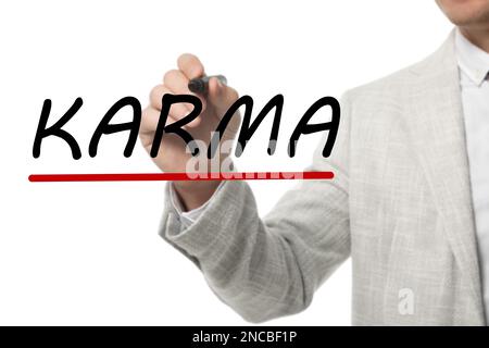 Ein Mann schreibt das Wort KARMA auf Glas vor weißem Hintergrund, Nahaufnahme Stockfoto