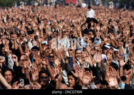 Shiite Muslims chant religious slogans during a Muharram procession, in ...