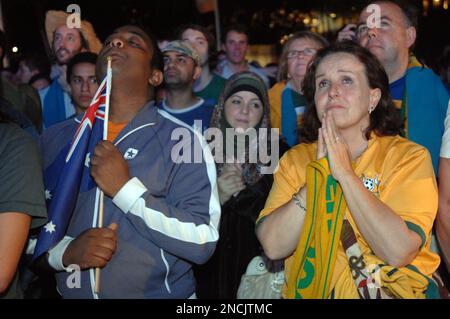 Australian's wait in the early hours of the morning at a live outdoor screening of the announcement of winners of the 2022 FIFA World Cup, Sydney, Friday, Dec.3, 2010. Australian lost its bid to host the 2022 event to the winning country, Qatar. (AP Photo/Jeremy Piper)