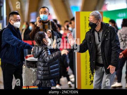 Peking, Chinas Provinz Yunnan. 15. Januar 2023. Ein Mädchen gibt ihrem Großvater einen High Five, der sie am Kunming Changshui International Airport in Kunming, Provinz Yunnan im Südwesten Chinas, abholte, am 15. Januar 2023. Kredit: Jiang Wenyao/Xinhua/Alamy Live News Stockfoto