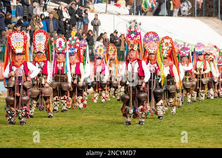 Typische Kukeri Startsi-Tänzer aus dem Dorf Kliment in der Region Karlovo beim jährlichen Simitlia Winter Festival in Simitli, Grafschaft Blagoevgrad, Bulgarien Stockfoto