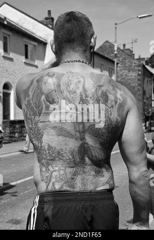 Ein Gentleman zeigt stolz sein Tattoo zurück, wo das Thema zu der Veranstaltung passt, an der er teilnimmt... die Appleby Horse Fair in Cumbria, Stockfoto