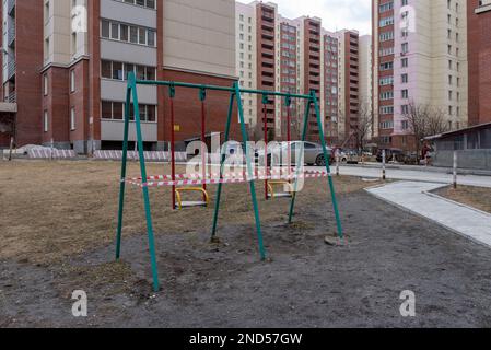 Nowosibirsk, Russland-12. April 2020. Schaukeln auf dem Spielplatz im Innenhof eines Apartmentgebäudes sind wegen des quara für die Öffentlichkeit geschlossen Stockfoto