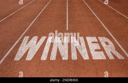Der Gewinner wurde auf der Laufstrecke geschrieben, Neues Konzept auf der Laufstrecke, Text in Weiß Stockfoto