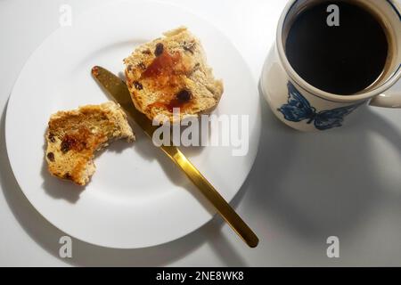 Getoastetes heißes Brötchen mit Marmelade und schwarzem Kaffee Stockfoto