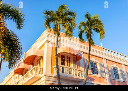 Altstadt von Naples, Florida Downtown am Third Street South Shopping District mit rosa Gebäude Architektur bei Sonnenuntergang mit Palmen und Baby Stockfoto