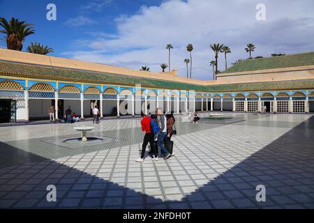 MARRAKESCH, MAROKKO - 20. FEBRUAR 2022: Touristen besuchen den großen Hof des Bahia-Palastes in Marrakesch. Das historische Medina-Viertel von Marrakesch gehört zum UNESCO-Weltkulturerbe Stockfoto