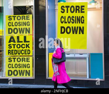 Glasgow, Schottland, Vereinigtes Königreich 17. Februar 2023. Papiere über die Art Meile des Bankrotts in der Buchanan Street, Postdetails und Verkaufsposter in ihrem Fenster, während ein alter Kunde sie liest... Credit Gerard Ferry/Alamy Live News Stockfoto