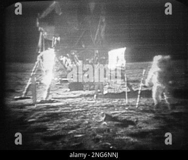 Apollo 11 astronaut Neil Armstrong, right, trudges across the surface of the moon leaving behind footprints, July 20, 1969. The U.S. flag, planted on the surface by the astronauts, can be seen between Armstrong and the lunar module. Edwin E. Aldrin is seen closer to the craft. The men reported the surface of the moon was like soft sand and they left footprints several inches deep wherever they walked. (AP Photo)