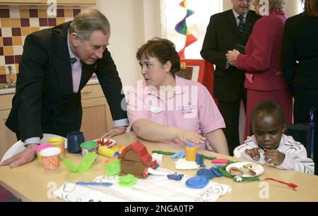 The Prince of Wales talks with staff during a visit with Duchess of Cornwall to open the Shooting Star House Children's Hospice in Hampton, south-west London, Tuesday 21st February, 2006. (AP Photo/Michael Dunlea/Dail Mail, Pool)