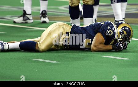 St. Louis Rams' Aeneas Williams, holds his son, Lazarus, as he celebrates  the Rams' 29-24 victory over the Philadelphia Eagles in the NFC  Championship game Sunday, Jan. 27, 2002 in St. Louis. (