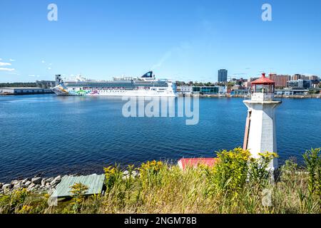 Kreuzfahrtschiff Norwegian Pearl im Hafen von Halifax und Blick auf den Leuchtturm von Georges Island - Halifax, Nova Scotia, Kanada Stockfoto