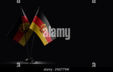 Kleine Staatsflaggen der DDR auf schwarzem Hintergrund. Stockfoto