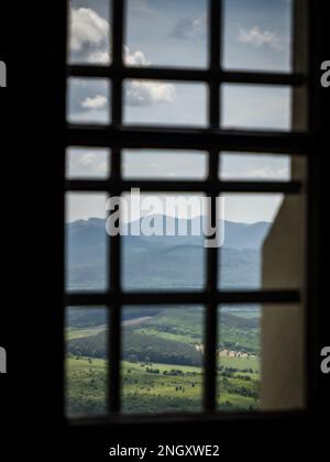 Berge Berge Hügel Wald Wolken Blick von einem verbargenen Steinfenster in einer Burg Fuzer (Füzér), Ungarn Stockfoto