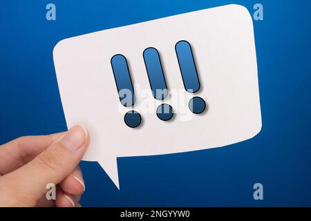 Sprechblase vor farbigem Hintergrund mit Ausrufezeichen. Stockfoto