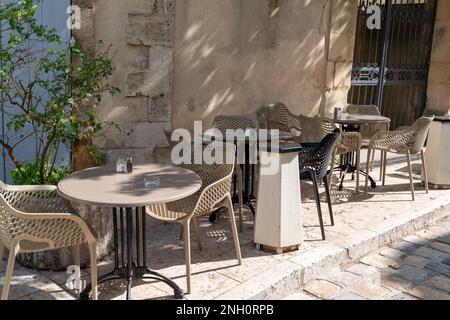 Leere Retro-Tische und -Stühle auf der Außenterrasse des Cafés in Avignon Frankreich Stockfoto