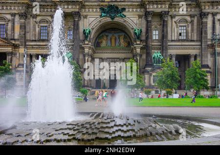 Lebhafte Szene am Brunnen im Lustgarten, Touristen und Einheimische geschäftig auf dem Platz vor dem Dom und dem Alten Museum, Berlin, Deutschland. Stockfoto