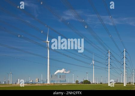Stromübertragungstürme vor einem niederländischen Kraftwerk in Eemshaven, Niederlande Stockfoto
