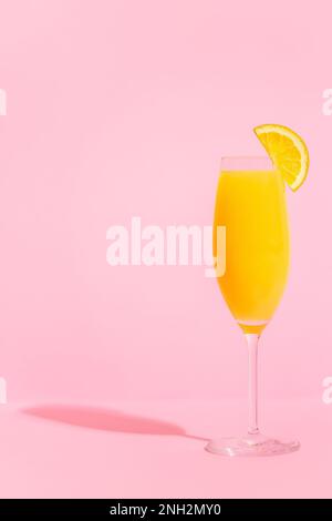 Erfrischende orangene Mimosa-Cocktails mit Champagner auf hellem Hintergrund. Stockfoto