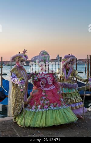 Karnevalsbesucher, die im Februar während des Karnevals 2023 in Venedig in prächtigen Kostümen und Masken gekleidet waren, am Markusplatz in Venedig, Italien Stockfoto