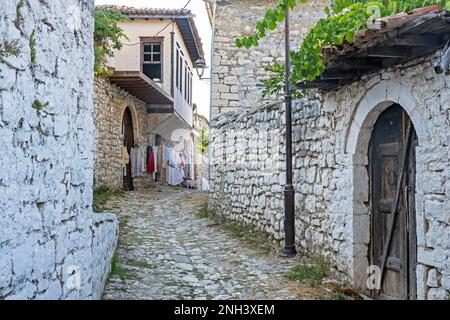 Enge Gasse mit Kopfsteinpflaster auf dem Burgberg, altes Viertel mit osmanischen Häusern in der Stadt Berat/Berati, Südalbanien Stockfoto