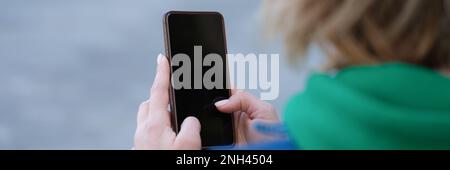 Frau hält Smartphone in der Nahaufnahme der Straße in den Händen Stockfoto