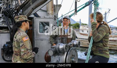 Bürgermeister Rick Berns, Bürgermeister von Old Harbor, Center, spricht über die wirtschaftlichen Auswirkungen des IRT Old Harbor Road-Projekts auf die lokale Gemeinde in Old Harbor, Alaska, am 18. Juli 2022. Stockfoto