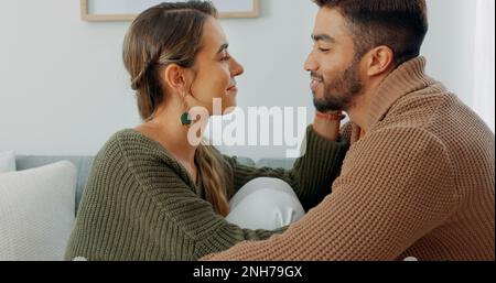 Liebe, Unterstützung und Zufriedenheit mit einem Paar zu Hause, das einen intimen Moment mit einem Kuss teilt. Lächeln, reden und Romantik mit einem jungen Mann und Stockfoto