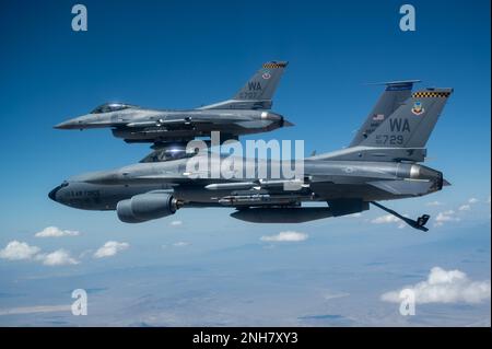 F-16C Fighting Falcons wurden der 64. Aggressor-Staffel zugewiesen, um von einem KC-135 Stratotanker aufzutanken, der 50. Luftwaffenstaffel, MacDill Luftwaffenstützpunkt, Florida, zugewiesen wurde, bevor er an einer Red Flag-Nellis 22-3-Trainingsmission am Nellis Luftwaffenstützpunkt, Nevada, teilnahm, 21. Juli 2022. Red Flag-Nellis 22-3 bietet realistisches Kampftraining, das Leben rettet und gleichzeitig die Kampfeffektivität steigert. Stockfoto