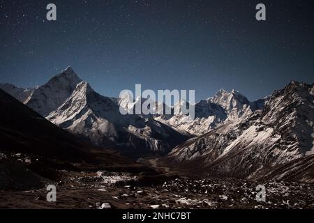 Panoramablick auf die Berge von AMA Dablam bei Sternennacht. Wunderschöne nächtliche Berglandschaft bei hellem Mondlicht. Sterne über dem himalaya, Stockfoto