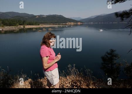 Mary Hamilton the President of the Scott Museum of Trinity Center on Friday September 9, 2011, in Trinity Center, Ca. The town of Trinity Center, now under water, was located just beyond the small boat docks in the background until it was relocated when the valley was flooded in 1961 to create Trinity Lake. Trinity Center, Stringtown, Minersville, Whiskeytown, Kennett - those and a dozen other once-booming towns are all buried underwater in Northern California reservoirs. But they are not forgotten. As the 50th anniversary of Shasta, Trinity and Whiskeytown reservoirs approaches, former reside