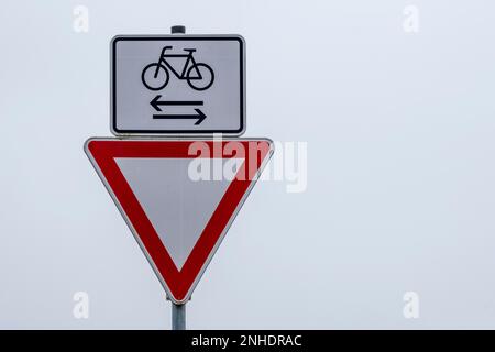 Straßenschild gibt nach und Achtung Radfahrer von links und rechts Stockfoto