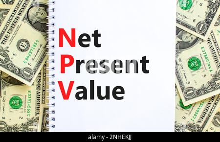 NPV net present value symbol. Concept words NPV net present value on white note on a beautiful background from dollar bills. Business and NPV net pres Stockfoto