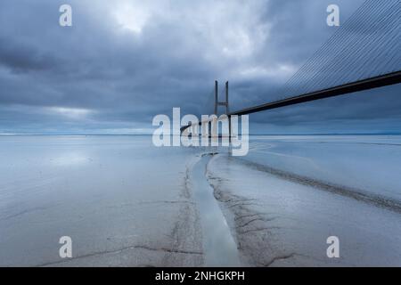 Nachtlichter auf der Lissabon-Brücke. Die Vasco da Gama Brücke ist ein Wahrzeichen und eine der längsten Brücken der Welt. Stadtlandschaft. Portugal ist ein Stockfoto