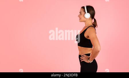 Seitenansicht Der Schönen, Sportlichen Frau Mit Kabellosen Kopfhörern Stockfoto