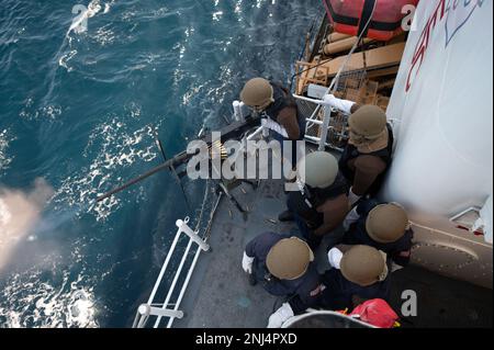 USA Küstenwache Petty Officer 3. Klasse Jacob Pollard, ein Lagerhalter an Bord des USCGC Bear (WMEC 901), feuert die .50 Kaliber Waffe während einer Schießerei in Operation Nanook, Nordatlantik, am 5. August 2022. Pollard war einer von vier Schützen der Küstenwache, die die Waffe während der Übung aktiviert haben. Stockfoto