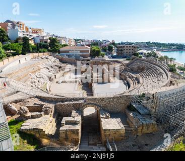 TARRAGONA, SPANIEN - 6. AUGUST 2022: Weitwinkelblick auf die Ruinen des römischen Amphitheaters in Tarragona, erbaut im 2. Jahrhundert v. Chr., mit dem Mediterr Stockfoto