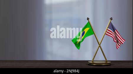 Flaggen Brasilien und USA auf dem Tisch. Verhandlungen zwischen Brasilien und den Vereinigten Staaten. Auf wenig unscharfem Hintergrund. 3D Arbeit und 3D Bild Stockfoto