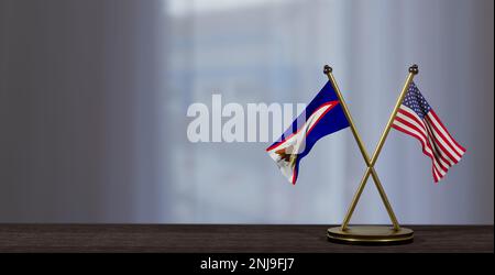 Amerikanisch-Samoa und USA-Flaggen auf dem Tisch. Verhandlungen zwischen Amerikanisch-Samoa und den Vereinigten Staaten. Auf wenig unscharfem Hintergrund. 3D Arbeit und 3D Bild Stockfoto