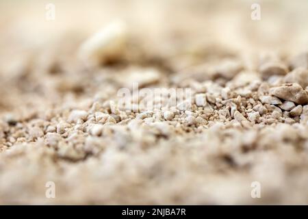 Details der Sandsteinstruktur Hintergrund nahtloser Sandselektivfokus. Makro-Nahaufnahme weicher Farben Stockfoto