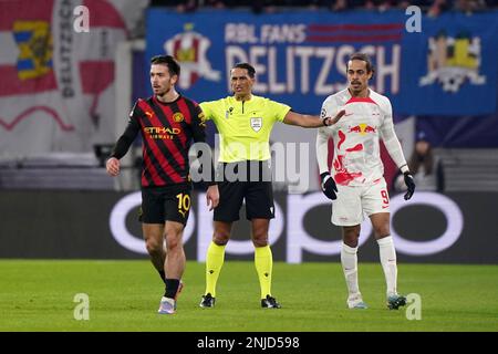 Der Schiedsrichter Serdar Gozubuyuk trennt Jack Grealish (links) von Manchester City und Yussuf Poulsen von RB Leipzig während der Champions League-Runde des ersten Teilchenspiels 16 in der Red Bull Arena in Leipzig. Bilddatum: Mittwoch, 22. Februar 2023. Stockfoto