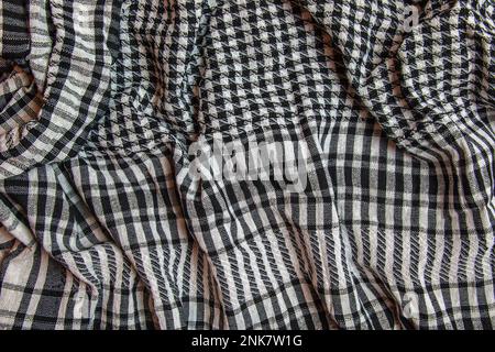 Hintergrund Textur, Muster. Schal wolle wie Yassir Arafat. Die Palästinensische Kufiya ist ein Geschlechtsneutraler kariert Schwarz und Weiß Schal, üblich ist Stockfoto