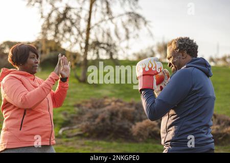 Ein Paar, das Boxen im Park praktiziert Stockfoto