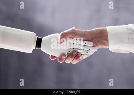 AI Robot Digital Machine und man Hand Handshake Stockfoto