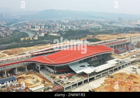 Fuzhou. 19. Februar 2023. Dieses Luftfoto wurde am 19. Februar 2023 aufgenommen und zeigt den Westbahnhof Fuqing der neuen Hochgeschwindigkeitsbahn Fuzhou-Xiamen in Fuqing, südöstlicher Chinas Provinz Fujian. Die 277 km lange Eisenbahnstrecke verläuft entlang der südostchinesischen Küste und durchquert drei große Buchten auf gigantischen Brücken. Es ist die erste Hochgeschwindigkeitsbahn des Landes, die das Meer überquert. Mit einer geplanten Geschwindigkeit von 350 km/h und acht Stationen entlang der Route wird die Reisezeit zwischen den beiden Städten voraussichtlich auf nur eine Stunde verkürzt. Kredit: Lin Shanchuan/Xinhua/Alamy Live News Stockfoto