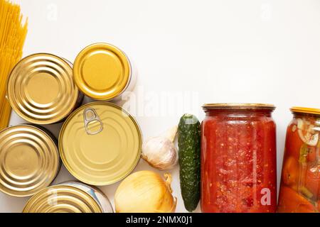 Verschiedene Konserven, Spaghetti und Zwiebeln, Gurken und Knoblauch und hausgemachte Tomatensoße auf weißem Hintergrund, eine Reihe von Produkten auf weißem Hintergrund Stockfoto