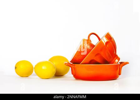 Küche und Geschirr. Geschirr aus gelber Keramik mit frischen Zitronen isoliert auf weißem Hintergrund. Speicherplatz kopieren Stockfoto