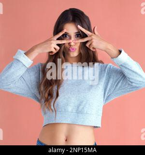 Sei du selbst, alle anderen sind vergeben. Studioaufnahme einer schönen jungen Frau, die vor einem rosa Hintergrund posiert. Stockfoto