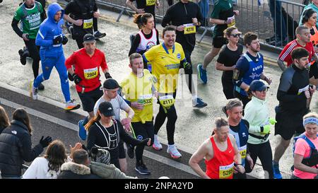 Brighton UK 26. . Februar 2023 Läufer , die die Ukraine unterstützen , nehmen an einem strahlenden Morgen an der Südküste am Brighton Halbmarathon 33. Teil . Über zehntausend Läufer sollen dabei helfen, Geld für verschiedene Wohltätigkeitsorganisationen zu sammeln: Credit Simon Dack / Alamy Live News Stockfoto