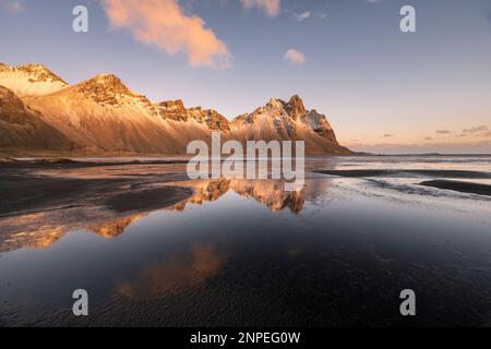 Der Vestrahorn-Berg spiegelt sich im nassen Sand wider. Stockfoto